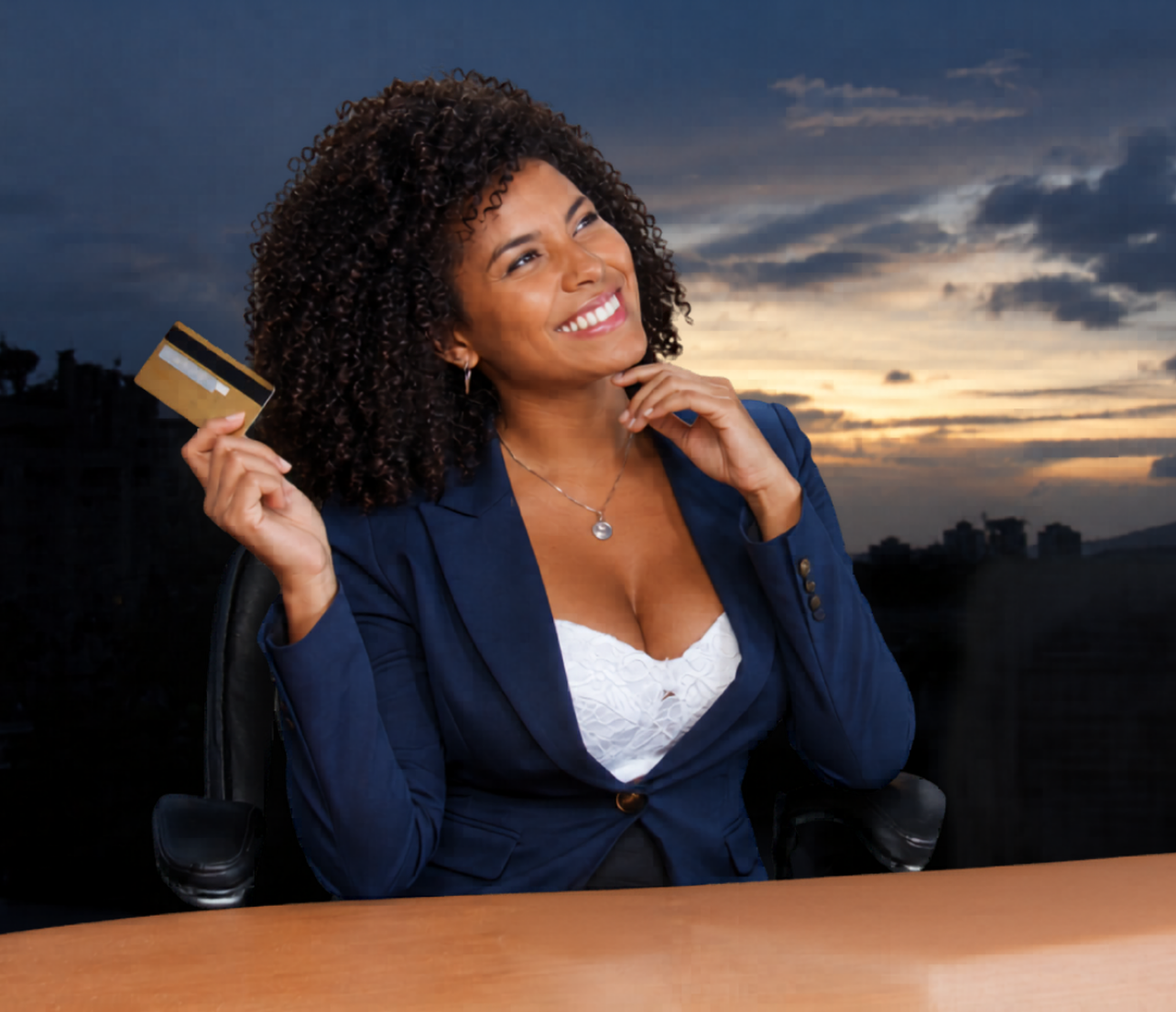 Business owner holding a credit card while reviewing Credit Intelligence and approval readiness decisions in a professional office setting.